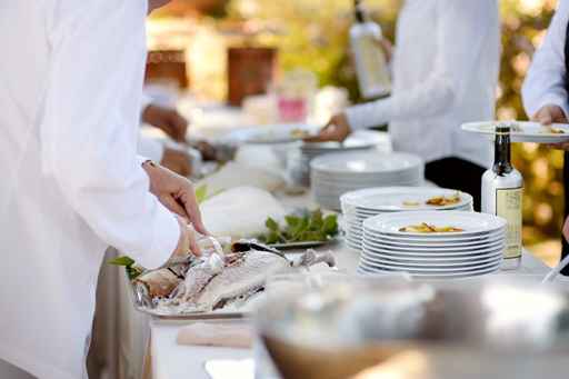 Waiter serving a tasty fish